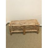 An Oliver Bonas canework two tier occasional table