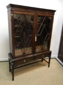 A circa 1900 mahogany display cabinet in the Georg