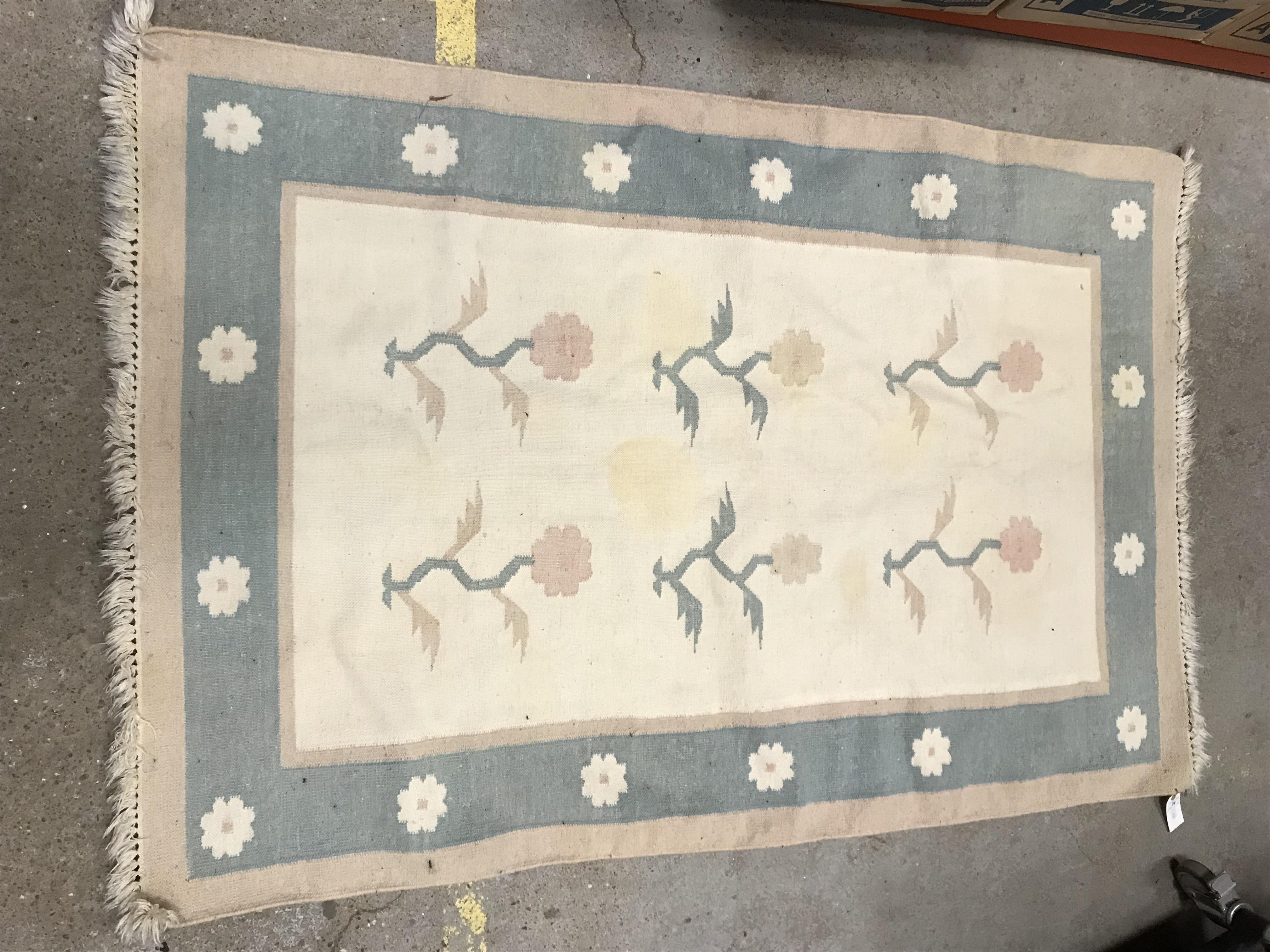 A modern rug, the central panel set with floral sp