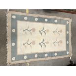 A modern rug, the central panel set with floral sp