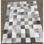 A modern John Lewis Cow hide patchwork rug, approx 240 cm x 170 cm