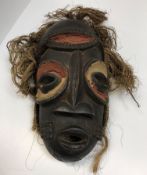 An African tribal mask with painted and carved dec