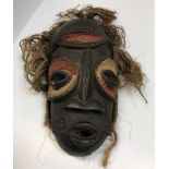 An African tribal mask with painted and carved dec