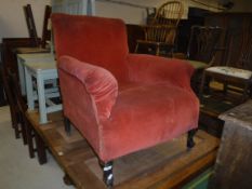 A circa 1900 upholstered scroll arm chair on cabriole front legs to castors, 73 cm wide x 67 cm deep