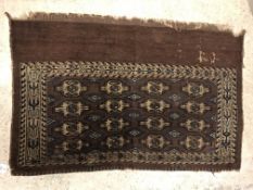 A Bokhara Juval rug, the main panel set with four