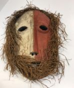 An African tribal mask with red and white painted