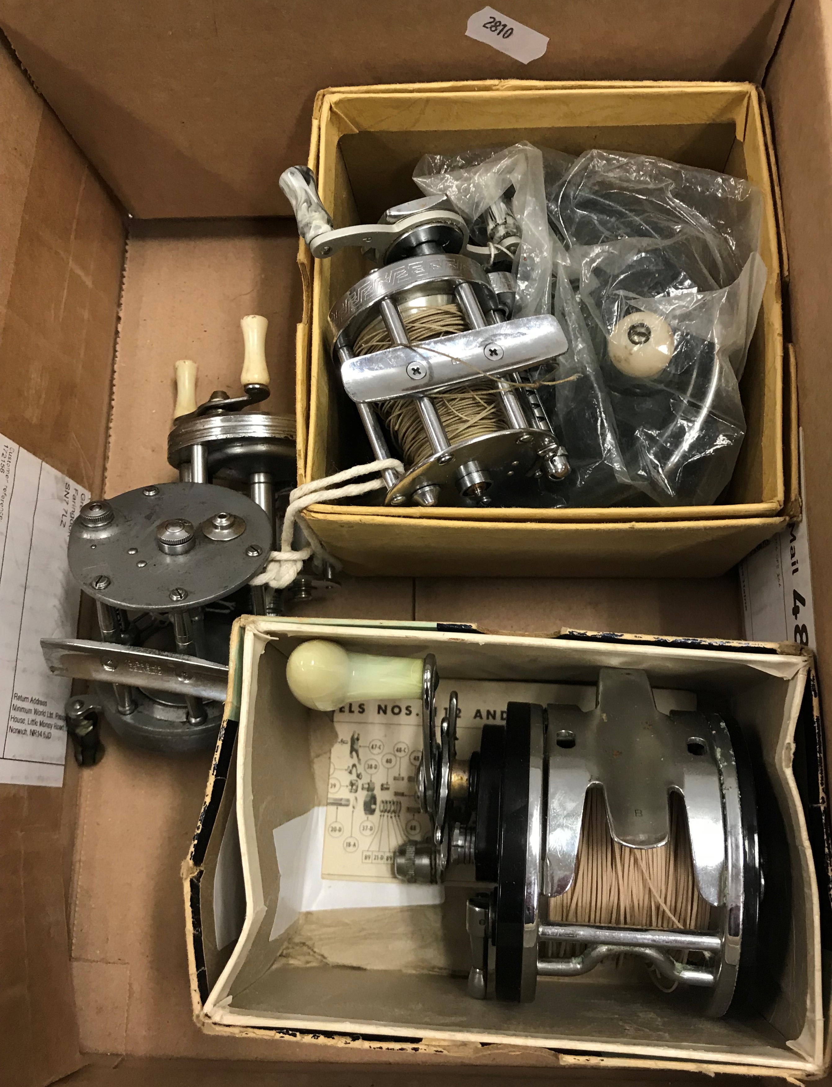 A collection of five fishing reels to include a Pflueger "Supreme" multiplying reel, a Pflueger "