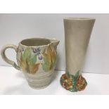 A Clarice Cliff Wilkinson trumpet shaped vase on floral decorated relief work base 27 cm high