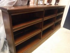 A circa 1900 mahogany open bookcase of three tiers of adjustable shelving, 245 cm wide x 28 cm