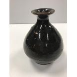 A Chinese treacle glazed vase of bellied form, bea