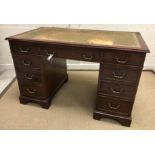 A modern mahogany double pedestal desk in the 19th Century manner, the tooled and gilded leather