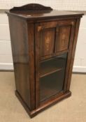 A late Victorian rosewood and marquetry inlaid music cabinet, the part glazed door enclosing four