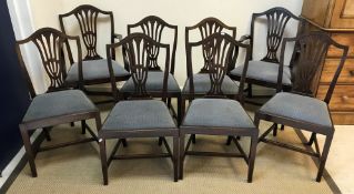 A set of eight early 20th Century mahogany Hepplewhite style dining chairs with pierced back
