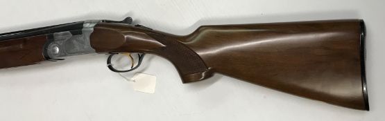 A Beretta S/G 12 bore shotgun, over and under, the side plates engraved with Spaniel to one side and