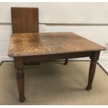 A Victorian oak rectangular extending dining table with single extra leaf on turned and ringed