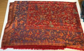 A modern shawl with floral and animal design on a red and blue ground, approx 204 cm long x 150 cm