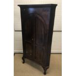 A late George III mahogany corner cupboard, the mo