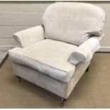 A modern upholstered scroll arm chair on