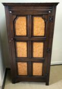 A mid 20th Century oak hall cupboard, th