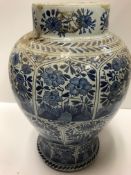A 19th Century Dutch Delft baluster shaped vase decorated with panels of flowers in the Chinese