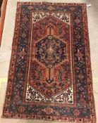 A Persian rug, the central panel set wit