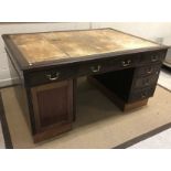 A mahogany partner's desk, the top with