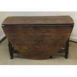 An 18th Century oak oval gate-leg drop-l