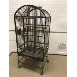A vintage wrought iron parrot cage with