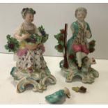 A pair of Chelsea figures of "Man seated