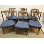 A modern set of six oak framed dining ch