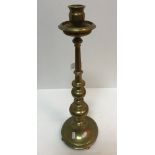 An early 20th Century brass candlestick