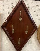 A set of four brass hat and coat hooks m