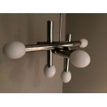 A chromium plated ceiling light fitting of abstract tubular form, the ends of the tubes fitted