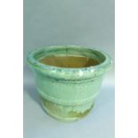 A large pale celadon green glaze earthenware planter, 52cm diameter x 41cm high