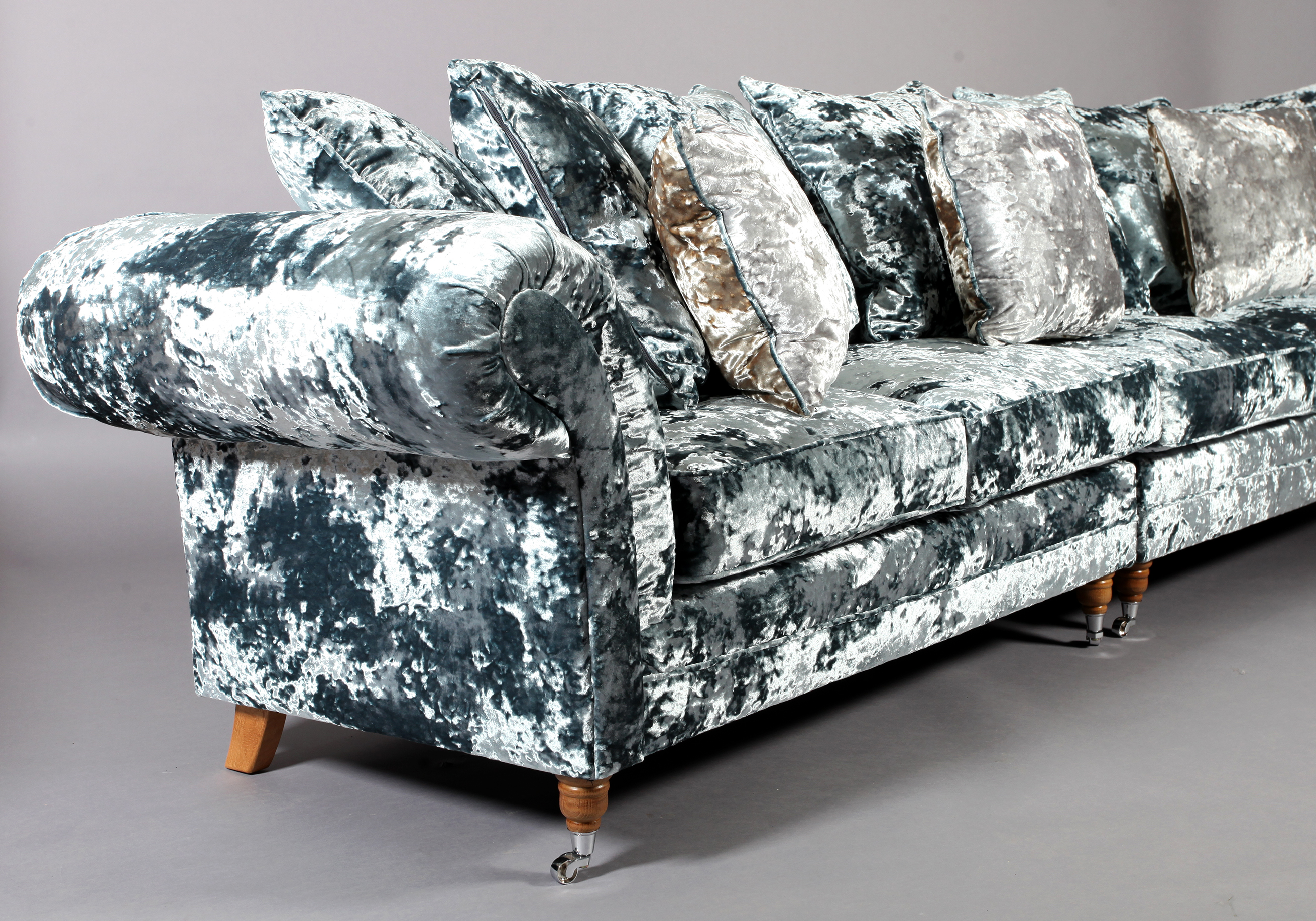 A four seater sofa upholstered in pale blue crushed velvet, on turned legs with chrome castors, - Image 2 of 4