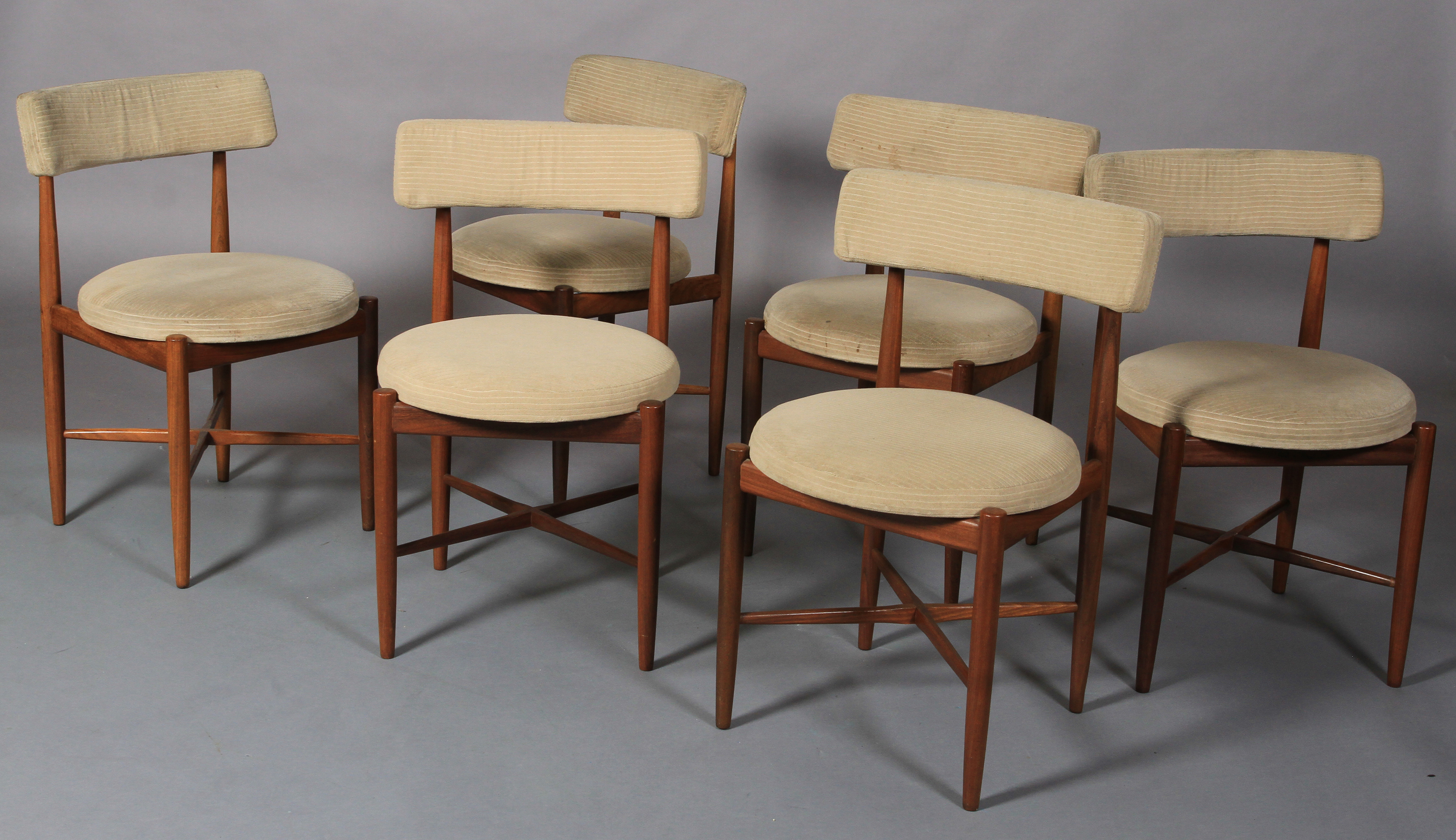 G Plan, a set of six teak dining chairs, pale corduroy upholstered bar back and circular seats, on