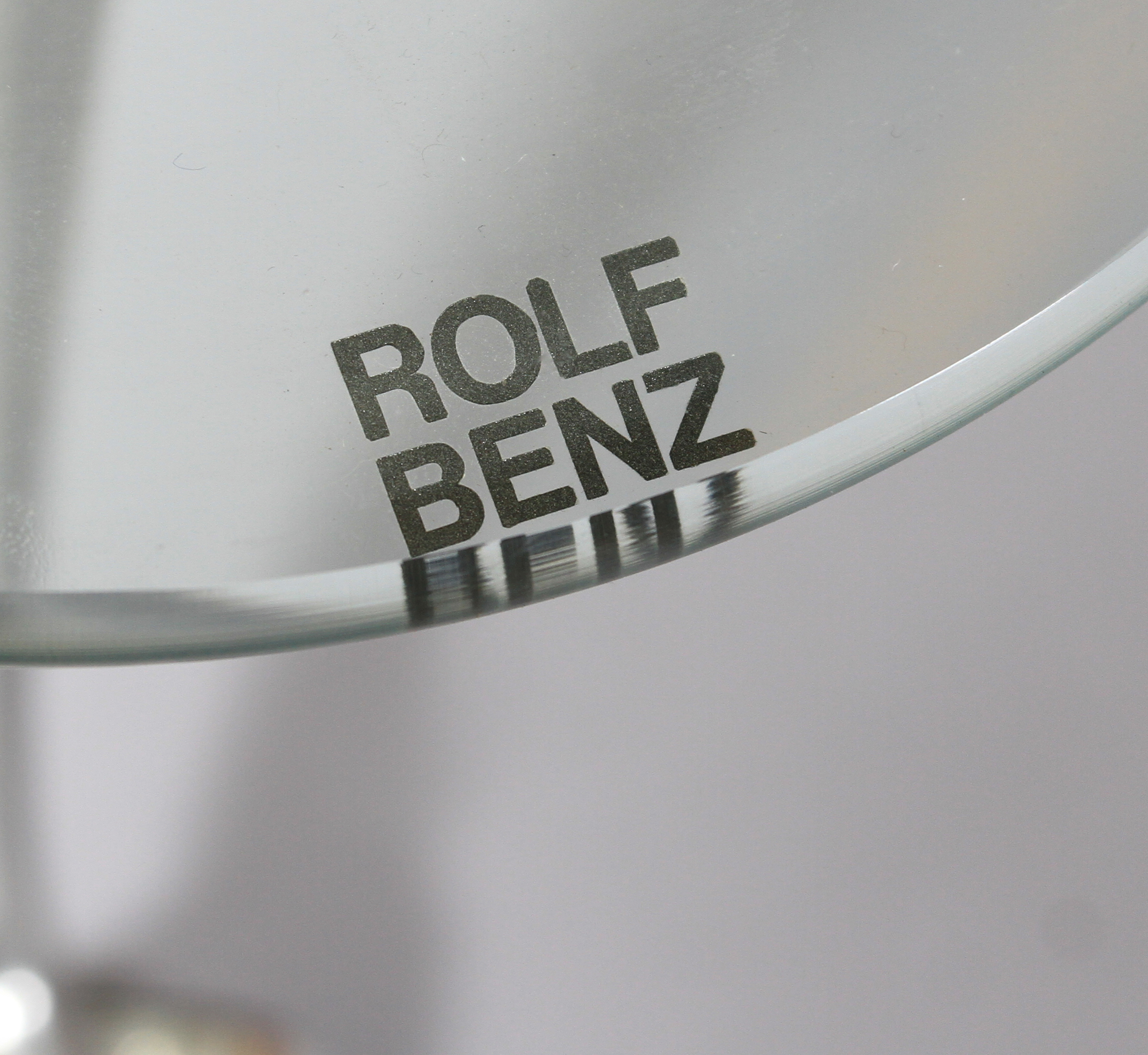 Rolf Benz - a glass and brushed aluminium coffee table, rounded triangular form on swept legs and - Image 4 of 5