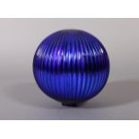 An irridescent ribbed blue glass spherical shade with open small cylindrical aperture, 22cm diameter