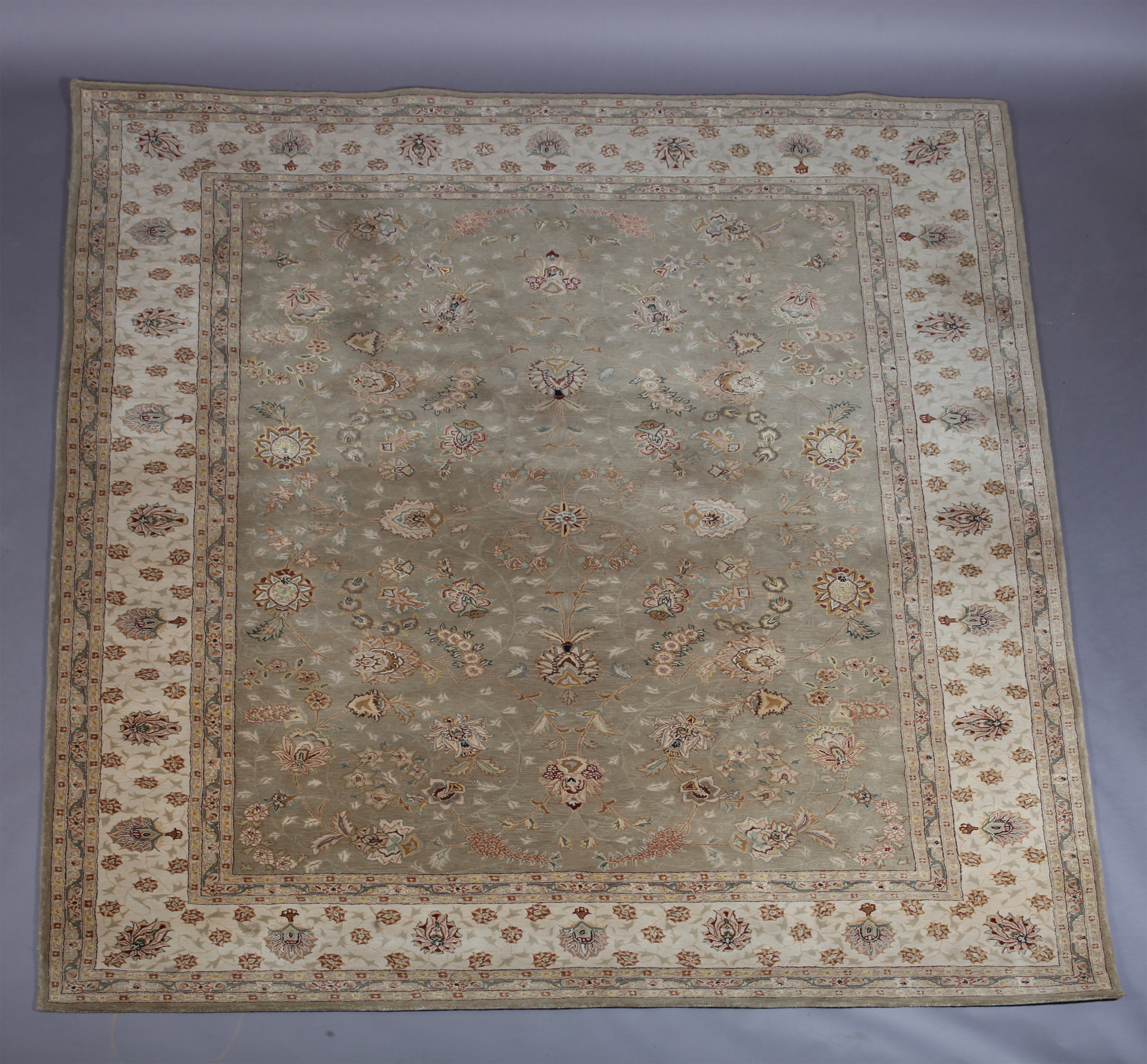 A Zeigler style carpet in pale olive within an ivory main border, 261cm x 351cm