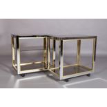 A pair of vintage brass and chromium plated drinks trolleys with smoked glass shelves, one with