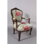 A French fauteuil style open armchair, encircling frame and floral upholstered back and seat, on