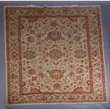 A Persian style carpet in camel and fox red, woven with scrolling tendrils and flowerheads and