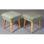 A pair of beech c.1960's upholstered seats in pale green leather and on splayed legs, 40cm square