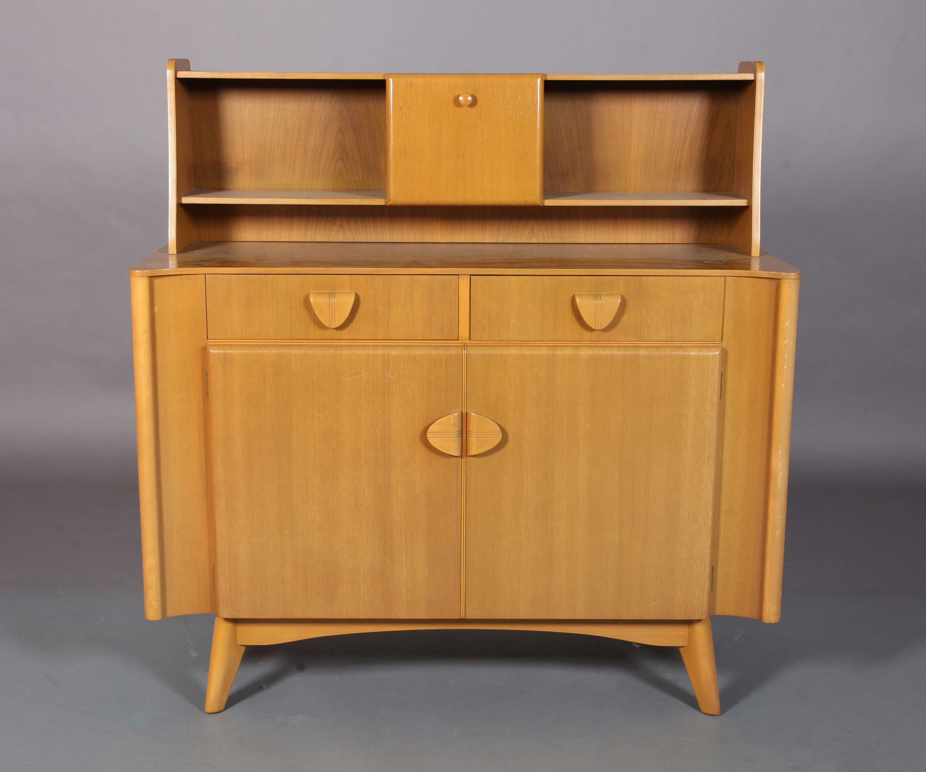 Nathan Products c.1955/60s a beech veneer sideboard raised back with central cupboard and open