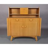 Nathan Products c.1955/60s a beech veneer sideboard raised back with central cupboard and open