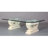 A bevelled glass coffee table on cast stone-effect twin scroll base, rectangular with cut corners,