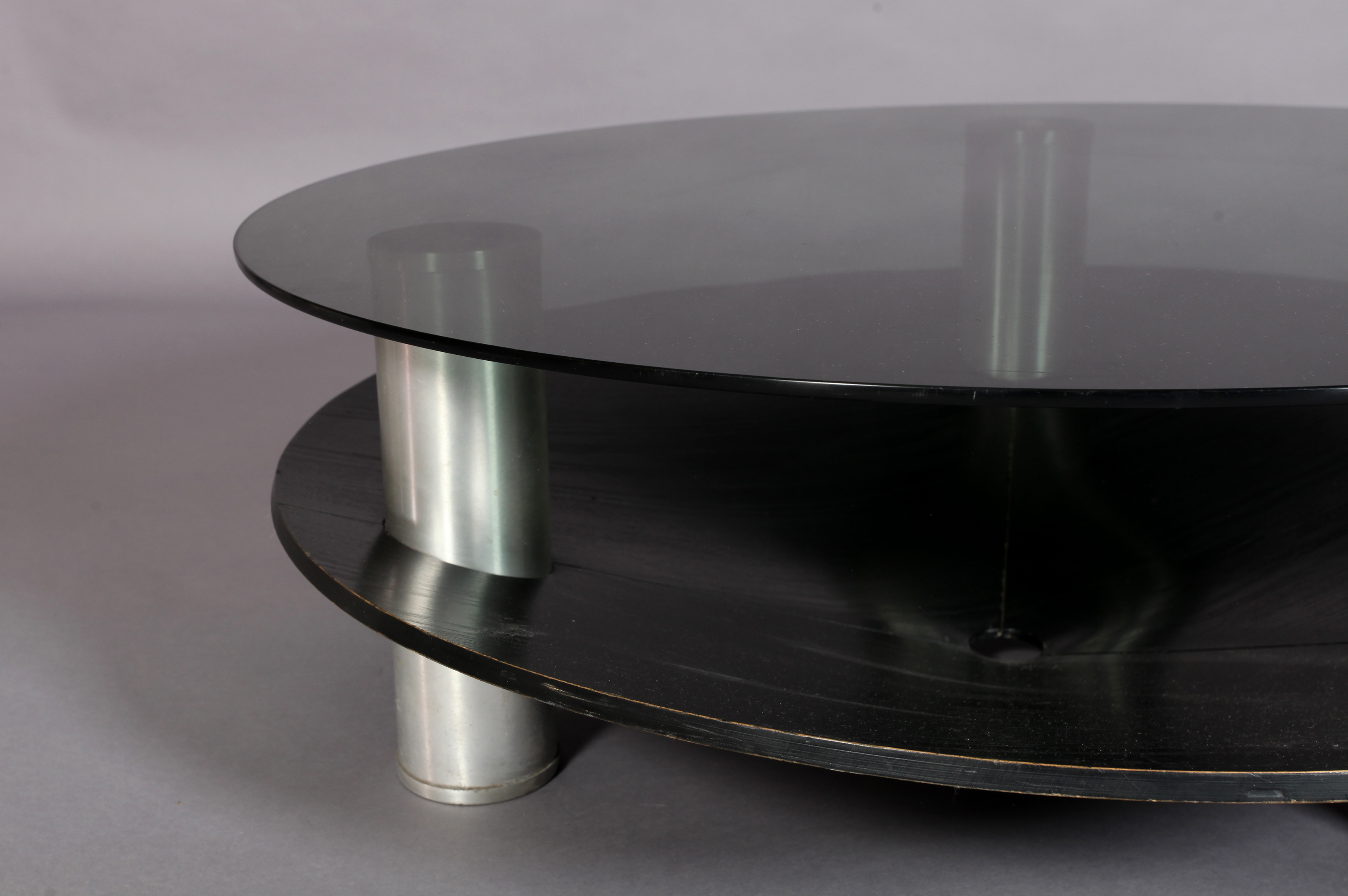 A circular two tier coffee table, the smoked glass top supported on three cylindrical aluminum - Image 4 of 4