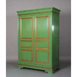 A French armoire by Grange, in green, highlighted with natural cherry, having a pair of triple