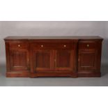 A Grange French cherrywood breakfront side cabinet, having one long central drawer flanked by a