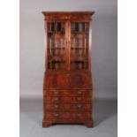A George III mahogany designed bureau-bookcase crossbanded and boxwood strung, having two astragal